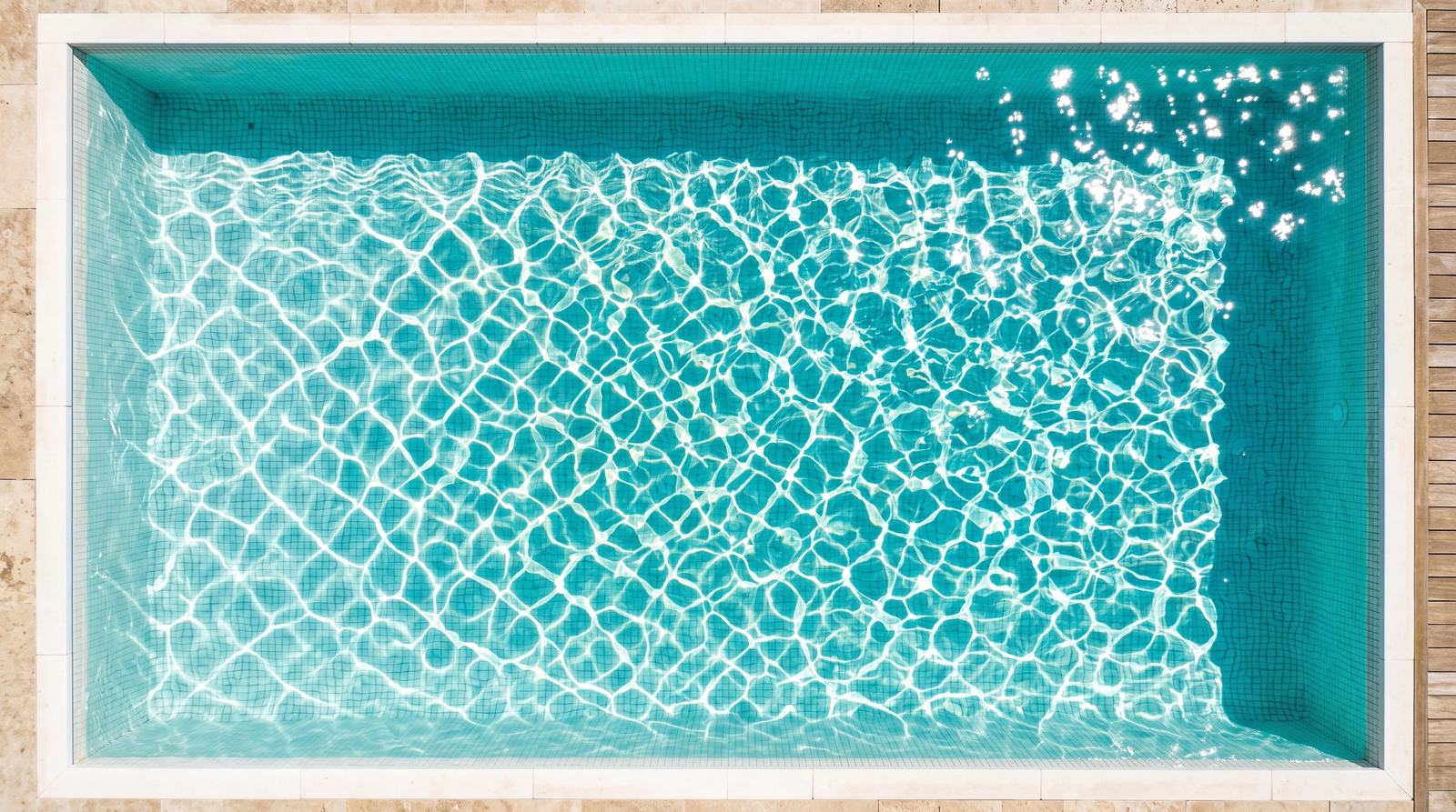 Sunlit swimming pool from above